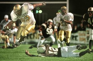 Valley’s Donny Booker (22) leaps over Highlands defender Justin Bouch on Oct. 13, 2000 on his way to a two-touchdown, 157-yard performance to give the 7-0 Vikings a 21-7 victory.