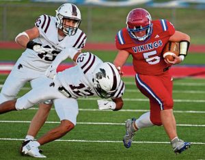 Mt. Pleasant’s Dane Firmstone stiff-arms Greensburg Central Catholic’ Samir Crosby on Aug. 29.