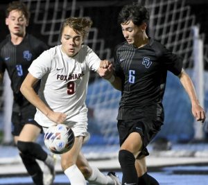 Fox Chapel’s Jake Williams battles Seneca Valley’s Owen Ali for possession Sept. 30.