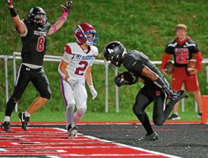 Southmoreland’s Ty Wjoric (8) celebrates as Averyon Darnell scores a first-quarter touchdown against Mt. Pleasant on Friday.