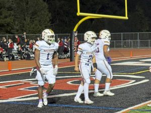 Plum's CJ Hart (left) and Antonio Hanzlik celebrate the Mustangs' fifth touchdown of the evening against Fox Chapel on Friday.