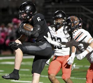 Upper St. Clair’s John Banbury leaps into the end zone to score past Bethel Park’s Brayden Bruckner on Friday, Oct. 10, 2025, at USC.