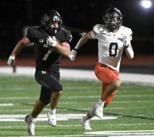 Upper St. Clair’s Dante Coury carries past Bethel Park’s Santino Nowozeniuk during their game on Friday, Oct. 10, 2025, at USC.