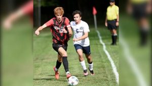 Sewickley Academy’s Finn Wentz works past Aquinas Academy’s Patrick Richthammer on Sept. 2.