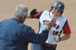 Shaler’s Bri Dobson rounds the bases past head coach Skip Palmer after hitting a two-run homer against Hempfield on April 27, 2016, in Shaler.