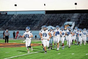 Brady Shearer (51) and Jayden Rosenberger (73) lead Leechburg onto the field at Clairton last week. The Blue Devils are 3-1 in the Eastern Conference.