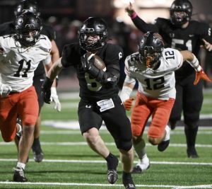 Upper St. Clair’s John Banbury carries through the Bethel Park defense last Friday.