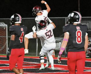 Elizabeth Forward’s Tyler Scott celebrates with Ryan Messina (16) after Messina’s touchdown run against Southmoreland on Friday.