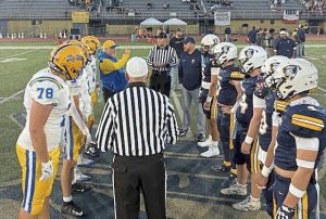 Players from Canon-McMillan and Norwin meet at midfield for the coin toss before their game Oct. 17, 2025, at Norwin.