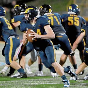 Mt. Lebanon quarterback Patrick Smith, shown scrambling against Peters Township last season, ran for three touchdowns against Hempfield on Friday.