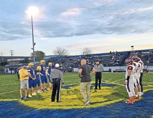 Players from Mt. Pleasant and Derry meet at midfield for the coin toss before their game Oct. 17, 2025, at Derry.