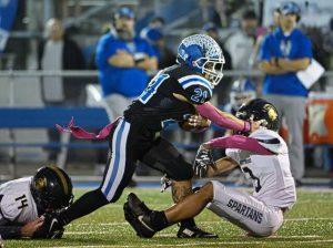 Leechburg running back Timmy Andrasy (21) powers through attempted tackles from Brentwood's Amir Mack (3) and Blaize Dias (14) on Friday, Oct. 17, 2025, at Veterans Memorial Field.