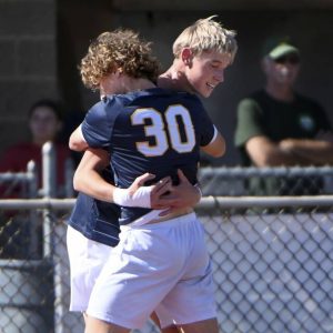 Mars’ Max Davis (30) hugs Logan Coone after Coone scored the go-ahead goal during their WPIAL Class 3A playoff game against Penn-Trafford on Saturday, Oct. 18, 2025, in Adams.