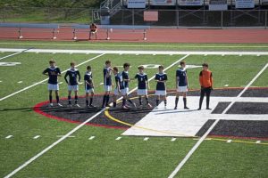 Players line up before Saturday's WPIAL playoff game between Riverview and Aquinas Academy.