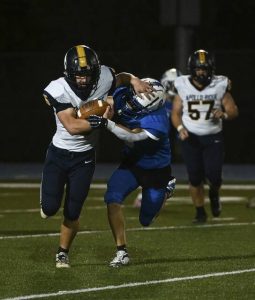 Apollo-Ridge’s Zac Myers holds off South Park’s Leland Stone as he carries the ball against South Park on Friday.
