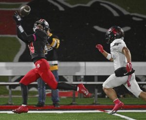 Southmoreland’s Stanley Betters beats Elizabeth Forward’s Aaron Ulmer for a catch Friday. The Scotties lost to the Warriors but still clinched a playoff spot.