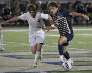 Franklin Regional’s Rory Bayne fights for the ball with Belle Vernon’s Chris Showman earlier this season.