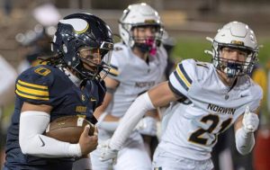 Central Catholic's Roman Thompson (0) turns the corner against Norwin's Carson Miller (21) on Thursday, Oct. 9, 2025, at Carnegie Mellon University.