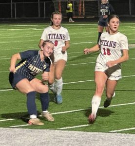 Franklin Regional's Ella Copeland (left) sends a pass downfield in front of Shaler's Naudia Zotter (9) and Melina Poliziani during a WPIAL Class 3A girls soccer playoff game Monday, Oct. 20, 2025, in Murrysville.