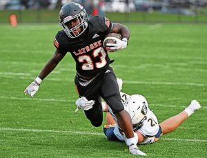Norwin’s Carson Miller tries to trip up Latrobe’s AJ Yeboah on Sept. 5.