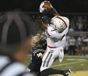 Highlands’ Jahmar Wright pulls in a catch over Freeport’s Kason Barker on Oct. 3.