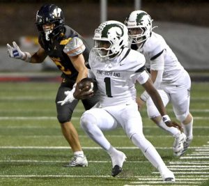 Pine-Richland quarterback Oobi Strader carries against Central Catholic on Aug. 29.