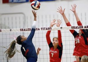 Shaler outside hitter Octavia Dixon attempts to tip the ball over Fox Chapel’s June Webb, left, and Emma DiRocco on Sept. 9.