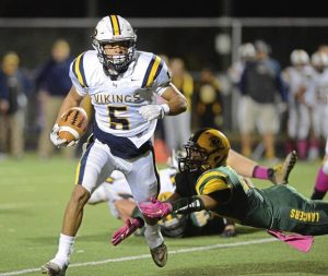 Apollo-Ridge’s Duane Brown dodges a tackle by Deer Lakes’ Justin Everetts (23) during the first half at Deer Lakes on Oct. 23, 2015.