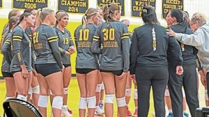 The Thomas Jefferson girls volleyball team gathers around coach Courtney Frost during the 2025 season.