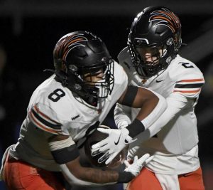Bethel Park quarterback Evan Devine hands off to David Dennison against Upper St. Clair on Oct. 10.