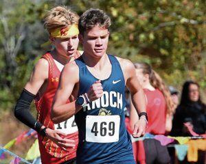 Knoch’s Carter French runs ahead of North Catholic’s Jack Steineman during the Class 2A boys race at the TSTCA cross country championship Oct. 16 at White Oak Park.