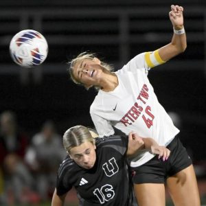 Peters Township’s Emory Van Ackeren battles Upper St. Clair’s Avery Bayer for a header on Sept. 10.