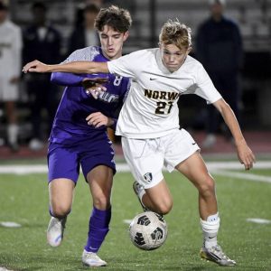 Norwin’s Logan Plichta battles Plum’s Christian Alter for possession Oct. 9 at Plum.