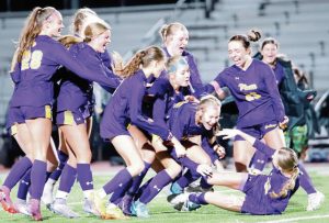 Plum celebrates Allison Porter’s winning penalty kick in a shootout victory over Mars in the WPIAL Class 3A quarterfinals Thursday.
