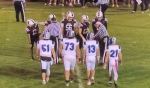 Players from Leechburg and Greensburg Central Catholic meet at midfield for the coin toss before their game Oct. 24, 2025, at GCC.