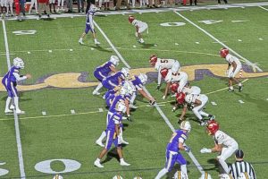 Penn Hills and Plum players wait for the snap Friday at Plum.