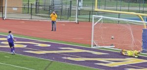 Plum soccer player Kent Holmes scores the game-clinching penalty kick Saturday in Saturday's WPIAL 4A quarterfinal game at Plum's Mustang Stadium.