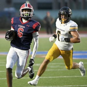 McKeesport’s Javien Robinson picks up yardage past Thomas Jefferson’s Zach Villa during their game on Friday, Sept. 5, 2025, at McKeesport.