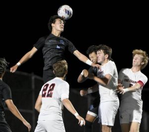 Seneca Valley’s Chase Lively heads the ball away off a corner kick against Fox Chapel on Sept. 30.