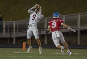 Greensburg Central Catholic’s Lucca Denis catches a pass as Jeannette’s Anthony Stuchell defends Oct. 3.