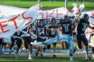 Members of the Kiski Area football team run through a banner at the start of their game against Knoch on Friday, Aug. 22, 2025, at Kiski.