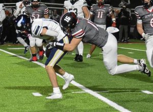 Southmoreland's Dawson Wolfe (right) tries to pull down Hopewell's Logan Triscila during a WPIAL Class 3A first-round game Oct. 31, 2025, at Southmoreland's Russ Grimm Field.