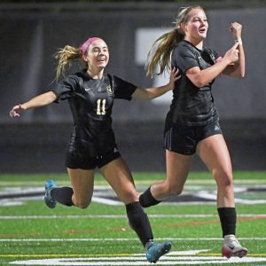 Quaker Valley’s Annabel Miko celebrates her first goal with Madeline Gatehouse during their game against Central Valley on Oct. 8 in Leetsdale.