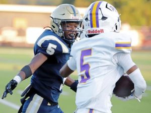Franklin Regional's Tyrone Leonard (left) tries to bring down Plum's Sloan Humphries on Friday, Aug. 22, 2025.