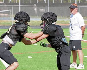 Quaker Valley’s Ben McHenry (left) battles Logan Benedict during a preseason practice.