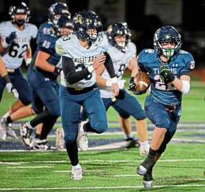 Shaler’s Isaac McKay (right) darts away from the Kiski Area defense on Friday during a WPIAL first-round playoff game.