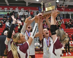 Beaver’s seniors celebrate with the trophy after beating Oakland Catholic in the WPIAL Class 3A volleyball championship Saturday at Peters Township High School.