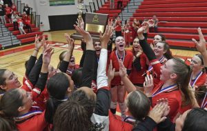 Peters Township celebrates with the trophy after beating Pine-Richland in straight sets during the WPIAL Class 4A volleyball championship Saturday at Peters Township High School.