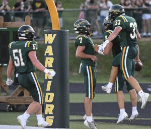 Penn Trafford’s Nate Desmond (7) and Landyn Stikkel celebrates with Ben Grabowski after Grabowski’s first-quarter touchdown against Norwin on Aug. 22.