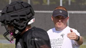 Quaker Valley head coach Tom Eshenbaugh works with his team during practice on Monday, Aug. 11, 2025, at Chuck Knox Stadium in Leetsdale.
